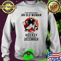 Never underestimate an old woman who loves hockey and was born in December Blood moon Sweater