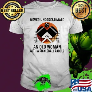 NEVER UNDERESTIMATE AN OLD WOMAN WITH A PICKLEBALL PADDLE SUNSET SHIRT
